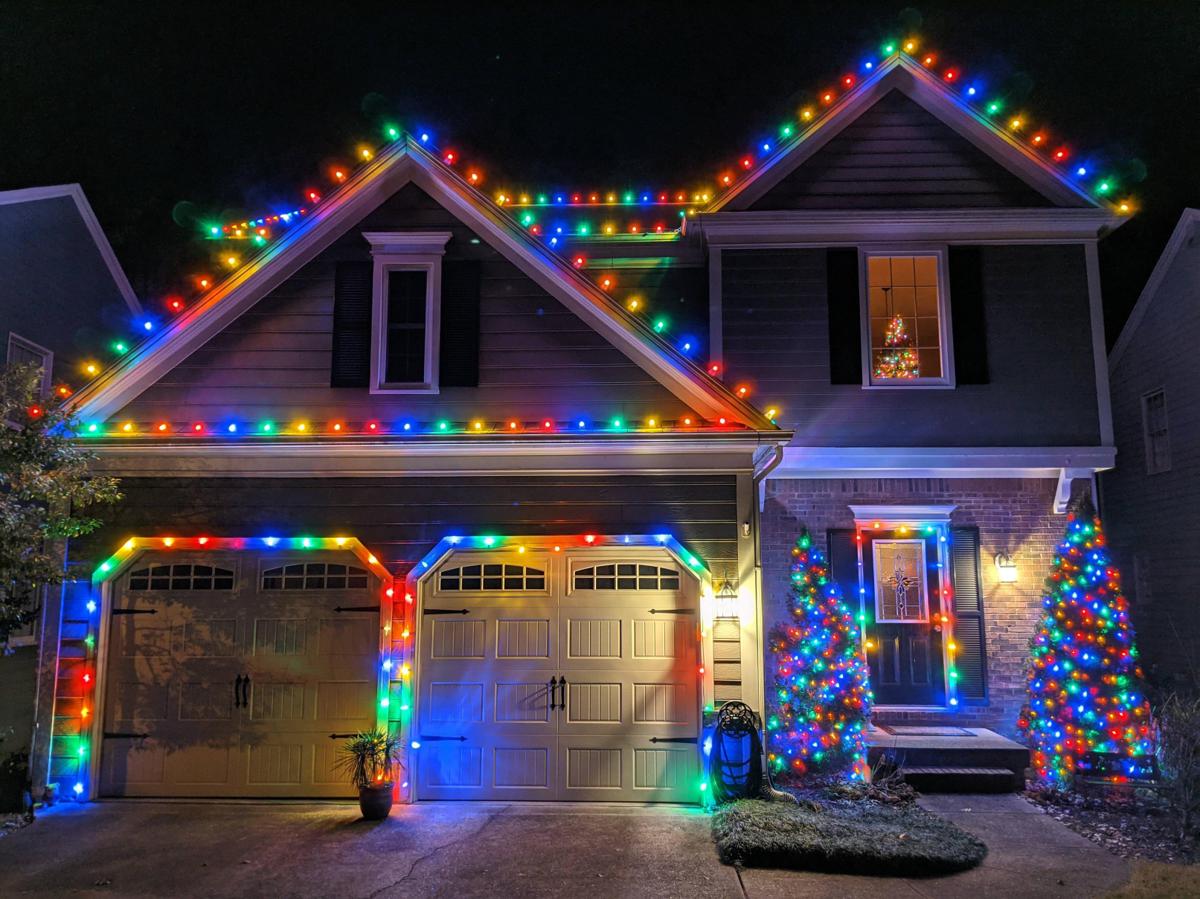 Professional Christmas light installation with warm bulbs outlining the full roofline