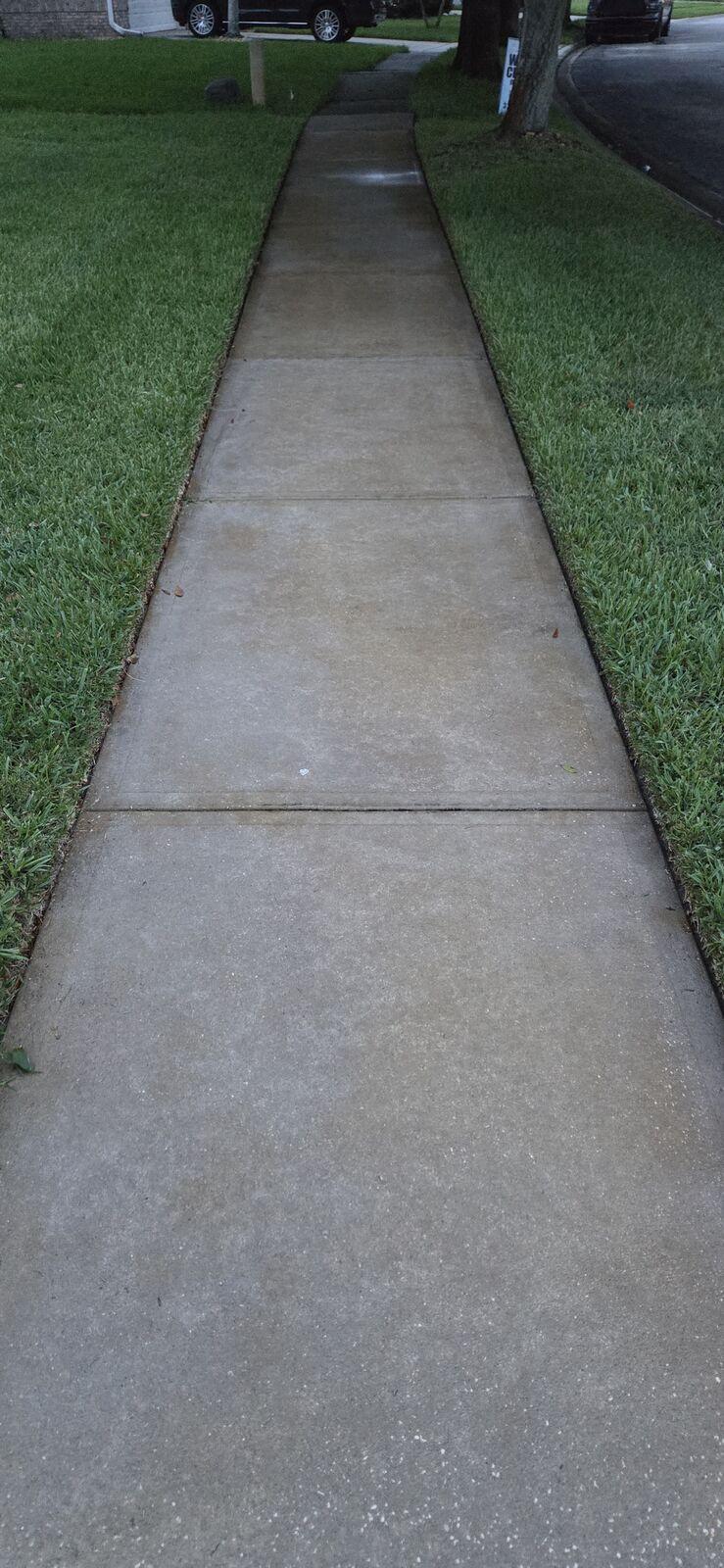 After: the same walkway pressure-washed back to bright concrete