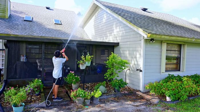 Seatown crew washing a screened lanai and its frame